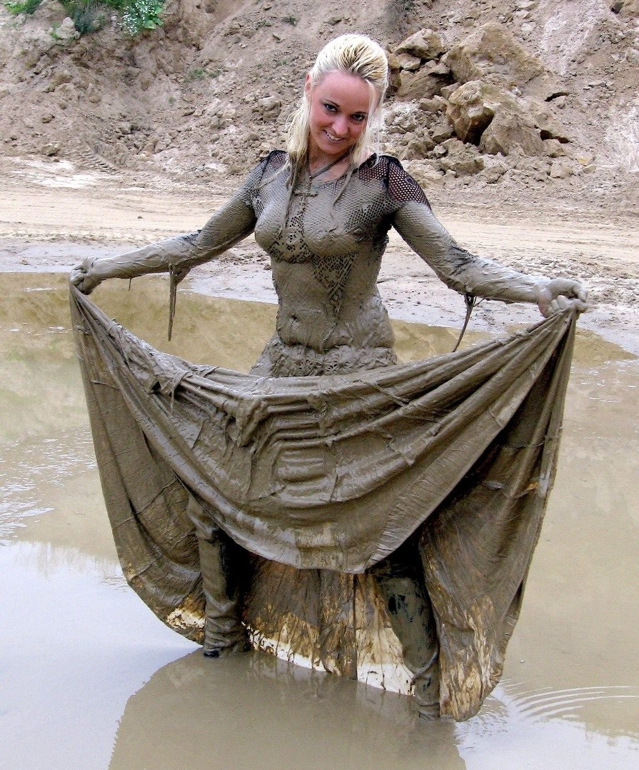 Blonde Woman wearing Black Fishnet Top and Muddy Long Skirt